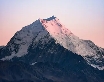 Snowy mountain peak at sunset