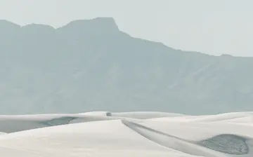 White sand dunes with mountains